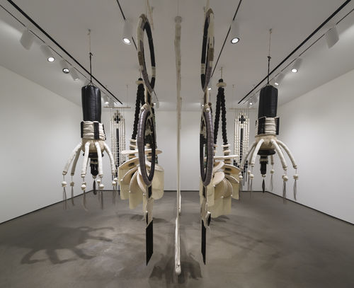 Art piece made of wood and rope hangs