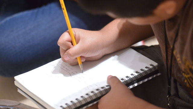 Kid writing a poem