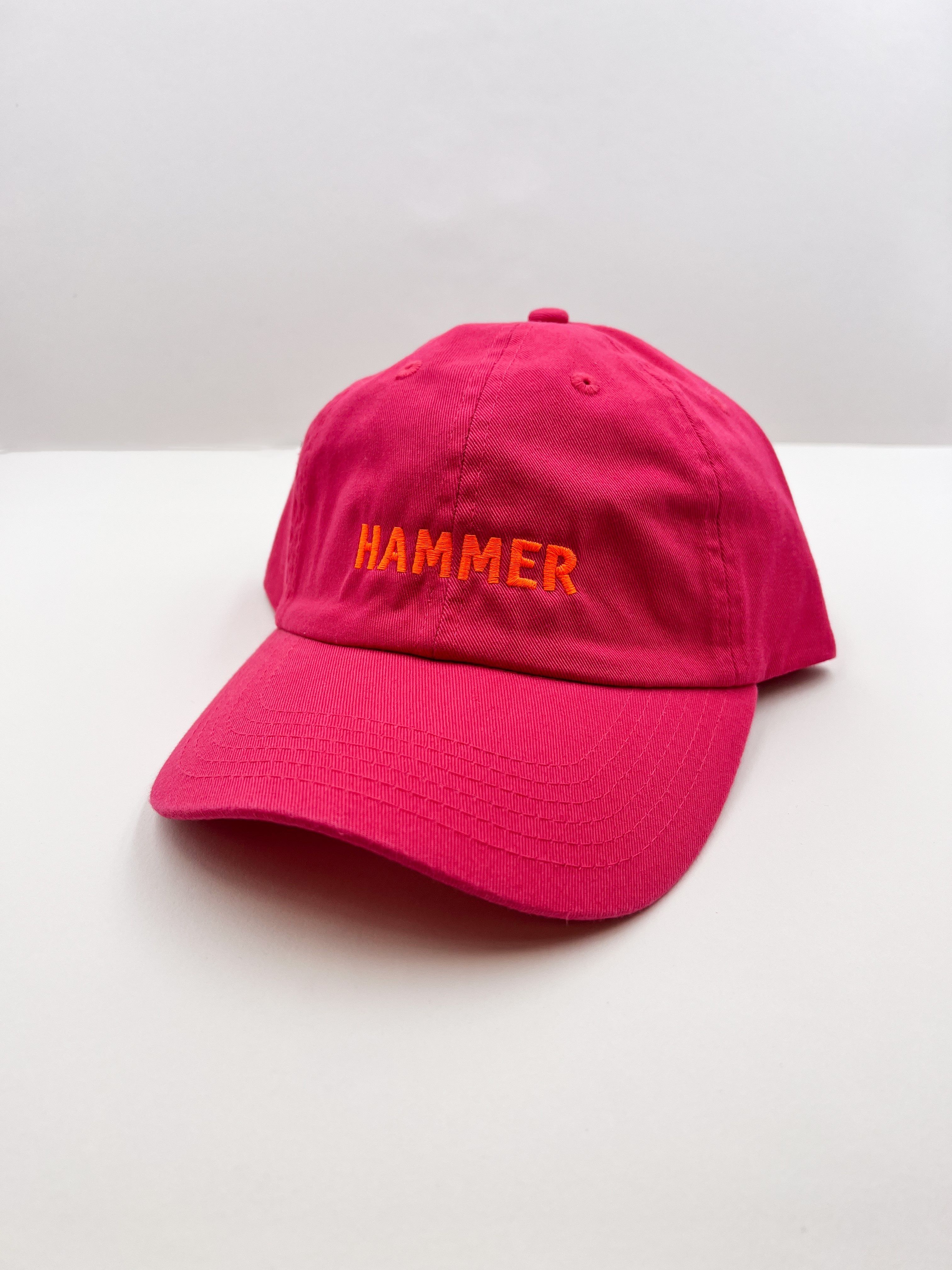 A hot pink hat with the word HAMMER