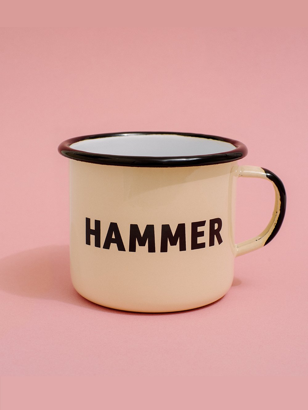 Cream colored mug with the text 'Hammer' on it. 