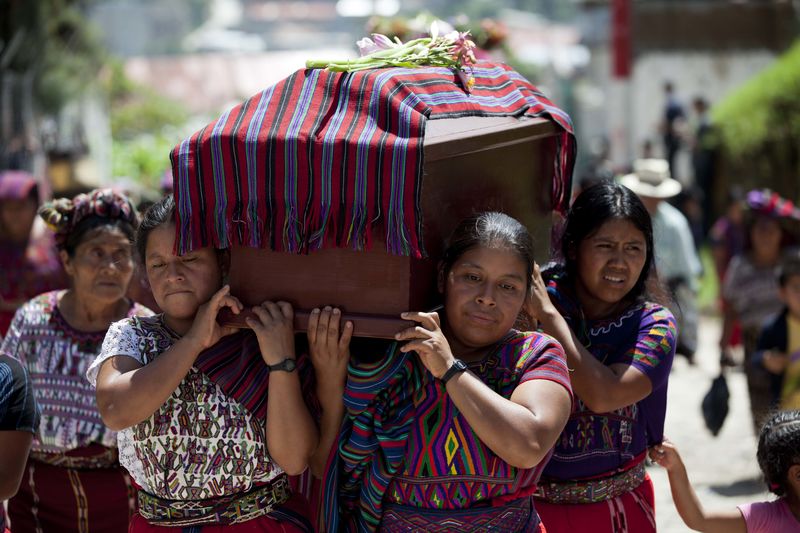 Relatives carry the coffin of one of 31 villagers massacred during the 1982 civil war,
July 30, 2014.