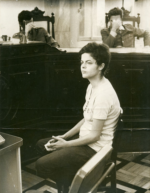 Fig. 1. Dilma Rousseff at the military audit headquarters, Rio de Janeiro, November 1970. Officers questioning her about her participation in the armed struggle conceal their faces with their hands