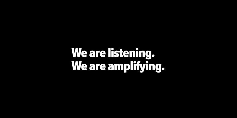 white text on a black background "We are listening. We are amplifying."