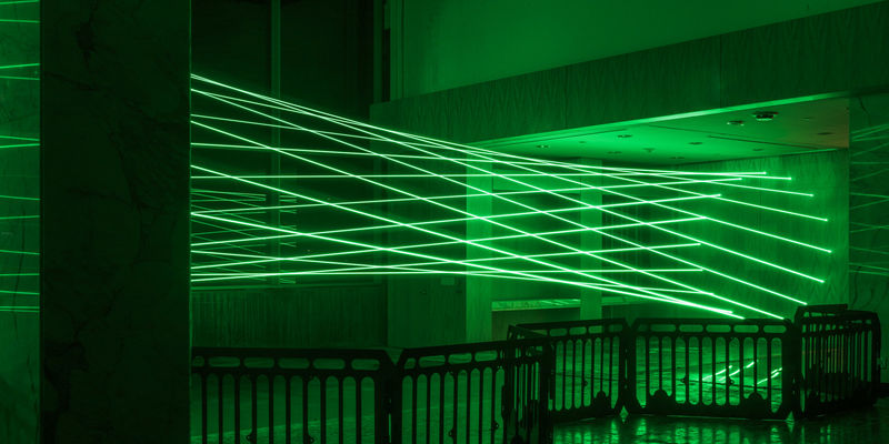 Green lasers fill a room