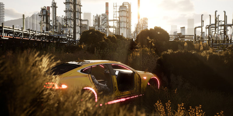 A dismantled yellow sportscar sits in a field