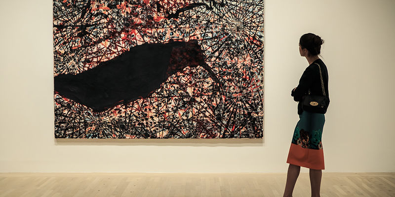 woman looking at painting