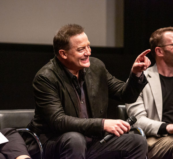 Brendan Fraser smiling and pointing at the audience