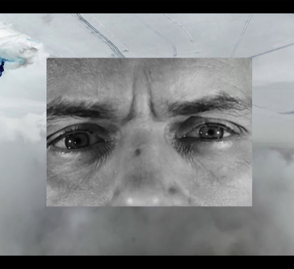 Black and white close up of a face, inset over an image of clouds