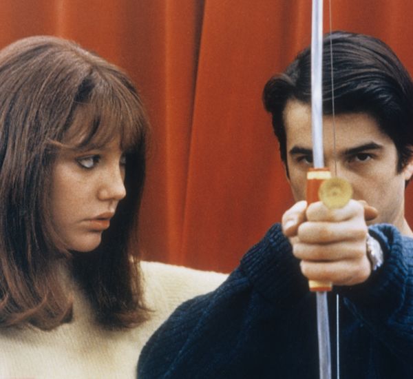 still from la chinoise of woman looking at man pointing arrow