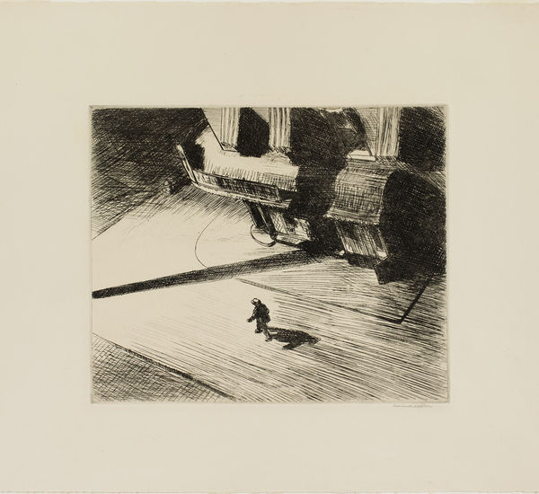 Overhead view of a city corner, with a lone figure walking down the street