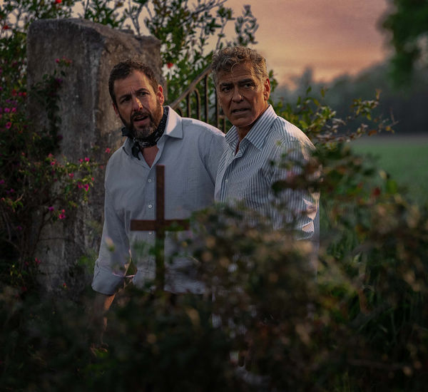 Adam Sandler and George Clooney look off-screen