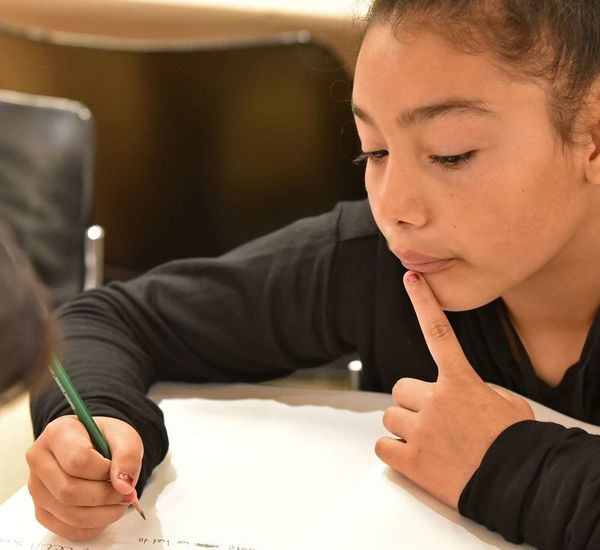 image of girl writing in journal