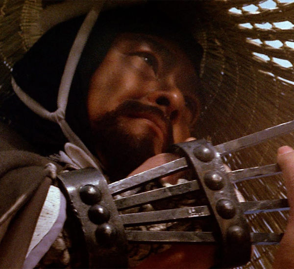 Extreme close up of a man with a metal claw attached to his hand