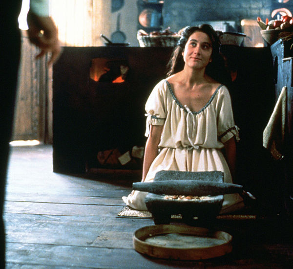 A woman kneels on the floor