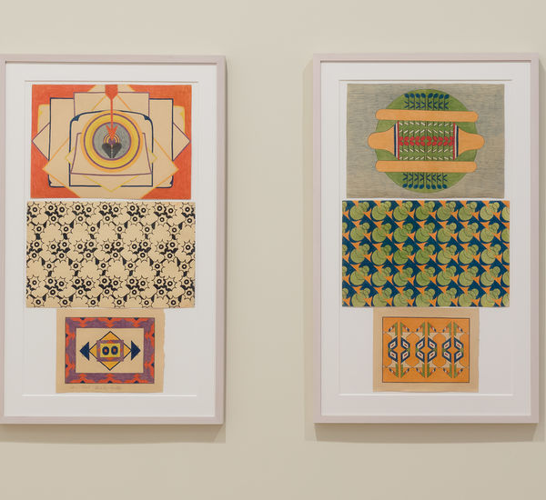 Two framed artworks on a wall with colorful geometric patterns