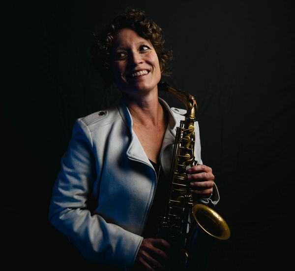 Kasey Knudsen holding a saxophone