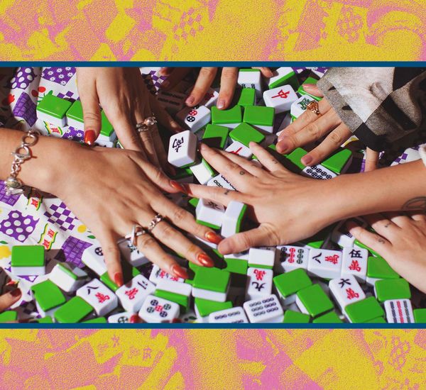Close up of hands playing mahjong