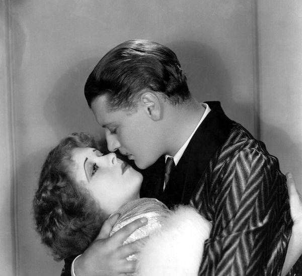 Black and white image of a man and woman embracing