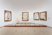 View of a gallery full of artworks