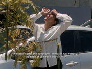 A figure in a white dress shirt and black pants puts eyedrops in her eyes