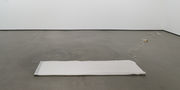 A gray electric blanket on an otherwise empty gallery floor