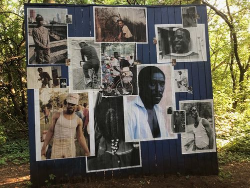A blue board covered in photographs