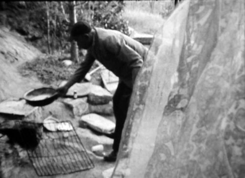Still from the film Cotton Eyed Joe (1970) showing a man living in an encampment