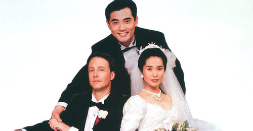 Still from the film The Wedding Banquet (1993) showing a two men in suits and a woman in a bridal gown