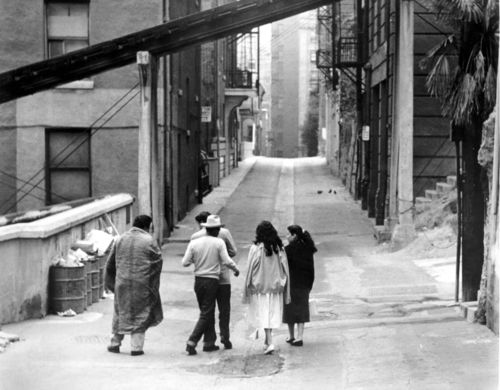 Still from the film The Exiles (1961) showing a group of teens walking down an alley