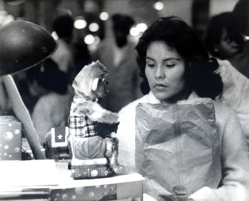 Still from the film The Exiles (1961), showing a woman looking a puppet