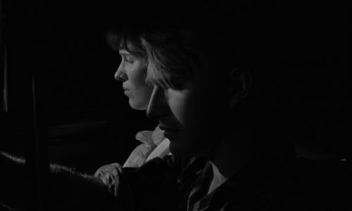 Still from the film Spring Night, Summer Night (1967) showing a close-up profile of two faces in shadows