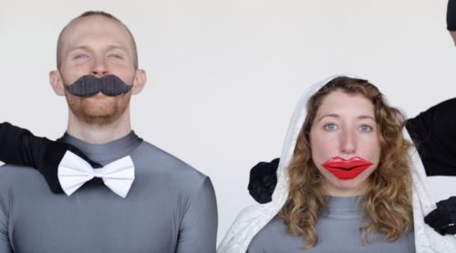 A man and a woman wearing a false moustache and false lips