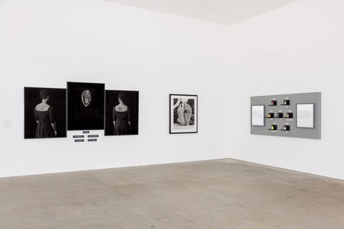 A white-walled gallery with several works hanging
