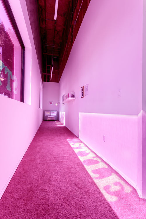 A hallway illuminated with pink light