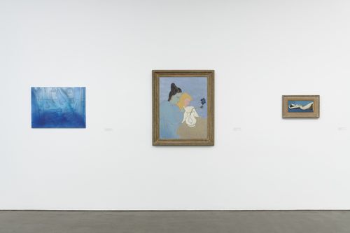 Three paintings hang on a gallery wall