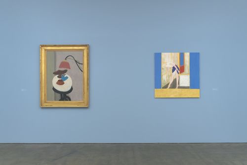 Two paintings hang on a blue gallery wall