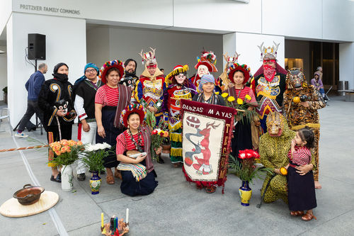A group of dancers gather and smile at the camera