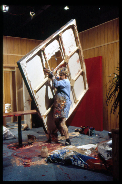 A man carries a large painting canvas