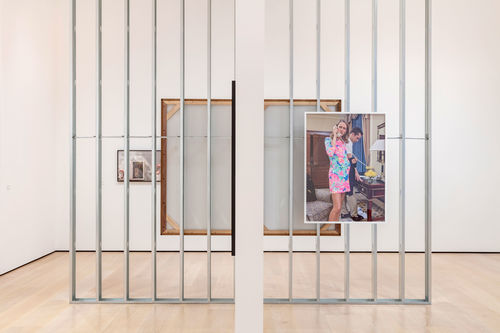 A museum gallery with a photograph hanging on an exposed wall