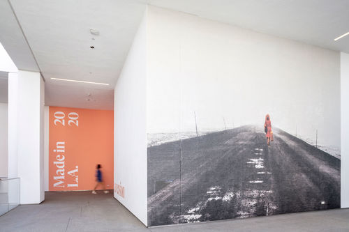 A hallway at the Hammer Museum, with a black-and-white photograph covering a whole wall, and a pink wall with Made in L.A. 2020 on it in the background