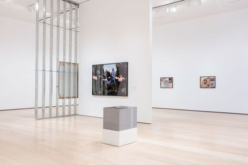 A view of a gallery with a large stack of printed material in the middle