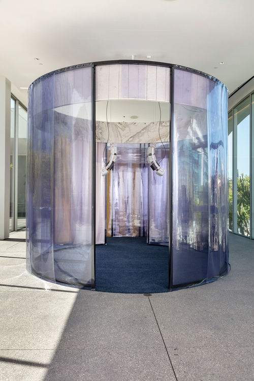 A large, oval structure with purple plastic sides