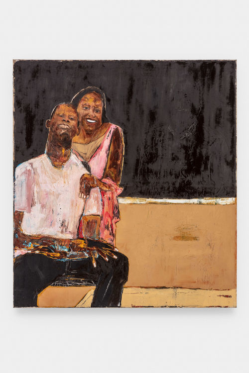 A portrait of a smiling couple before a black background