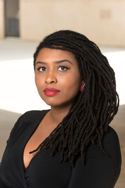 A photo portrait of a woman in a black top