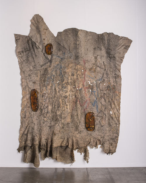 Large brown material in abstract shape similar to a sqaure. The texture mimics bark.