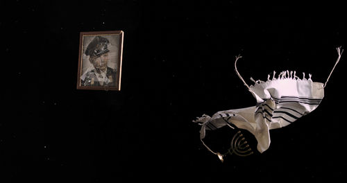 Blanket and broken picture frame floating in space