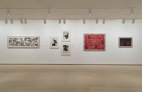 Gallery space with works on paper on the walls. 