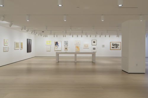 Gallery space with works on paper on the walls. 