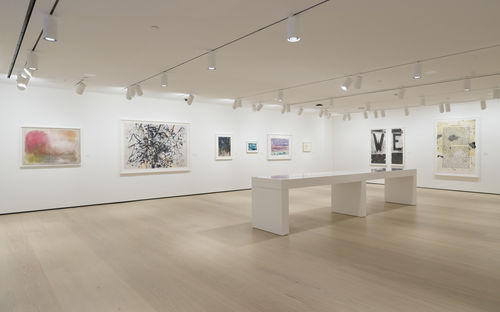 Gallery space with works on paper on the walls. 