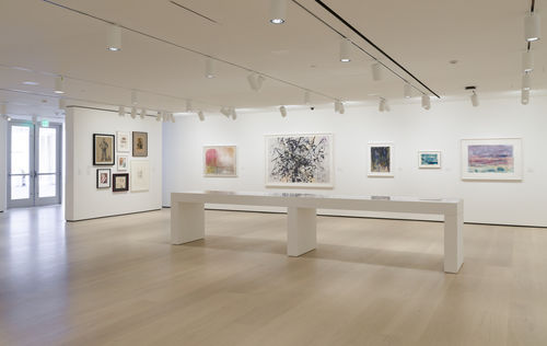 Gallery space with works on paper on the walls. 